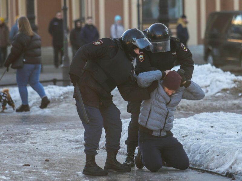 Two Russian policemen arrest a protester.