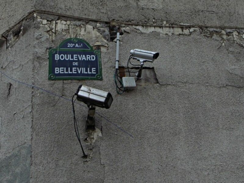 Two security cameras on a French street corner