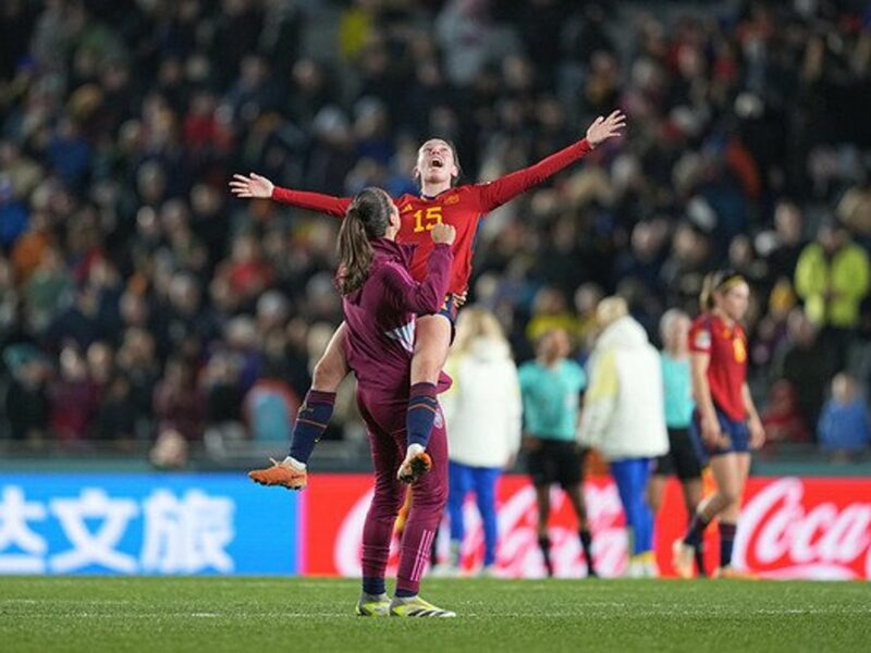 Two women soccer players celebrating.