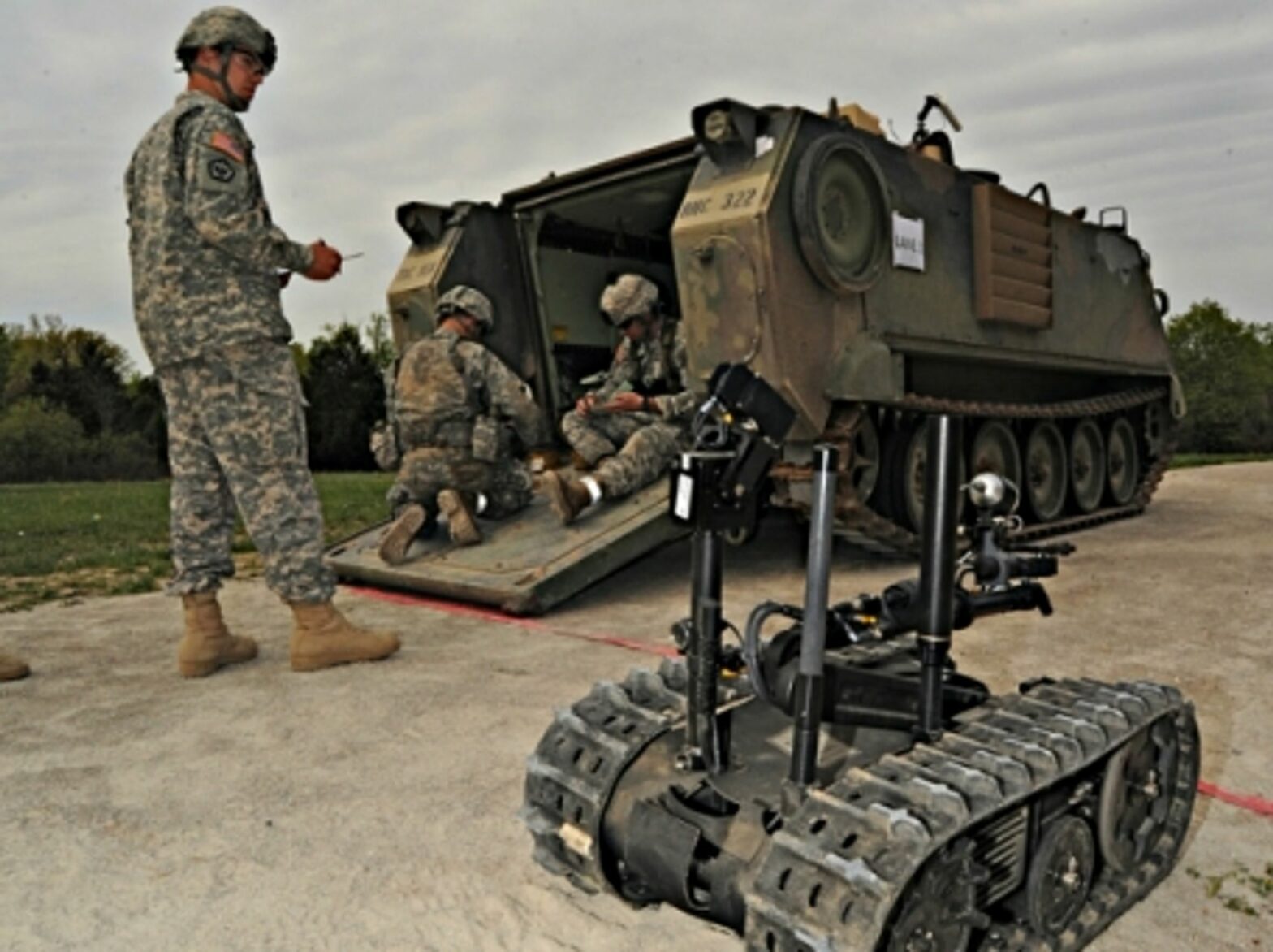 U.S. Army soldiers and a TALON robot, a military robot that is not (yet) autonomous
