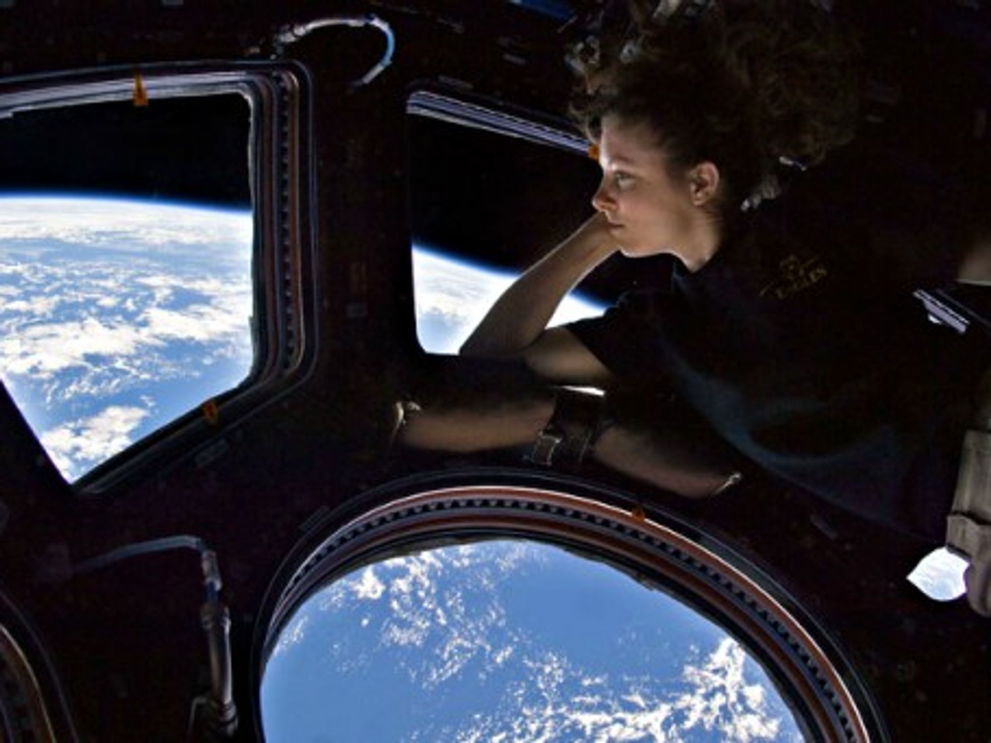 U.S. astronaut Tracy Caldwell Dyson looking out the ISS