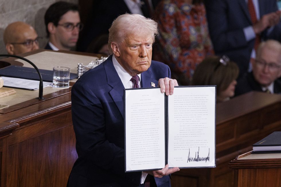 U.S. President Donald Trump holds a signed directive as he delivers his first State of the Union address of his second term to a joint session of the U.S. Congress in March 2025.