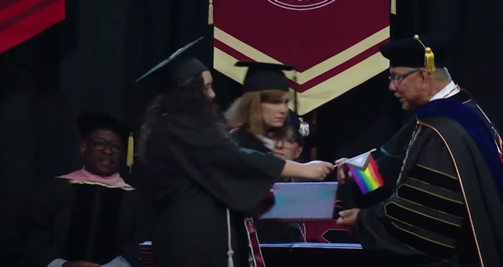 U.S. - Seattle Pacific University Graduates Hand President Pride Flags In Protest