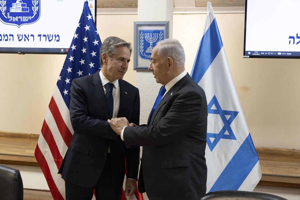 U.S. Secretary of State Antony Blinken, left, shakes hands with Israeli Prime Minister Benjamin Netanyahu during their bilateral meeting at the Kirya, October 12, 2023 in Tel Aviv, Israel.
