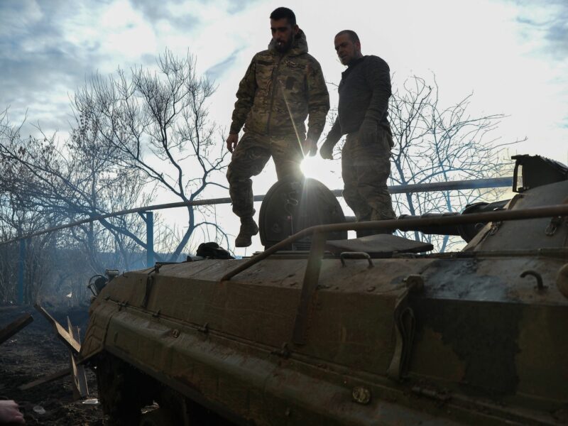Ukrainian BMP crew, stands on top of their vehicle outside the city of Avdiivka.