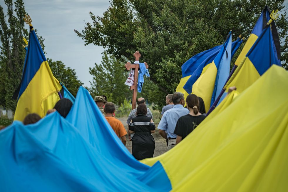 Ukrainian flags in a funeral procession of a soldier killed on the Ukrainian war front.