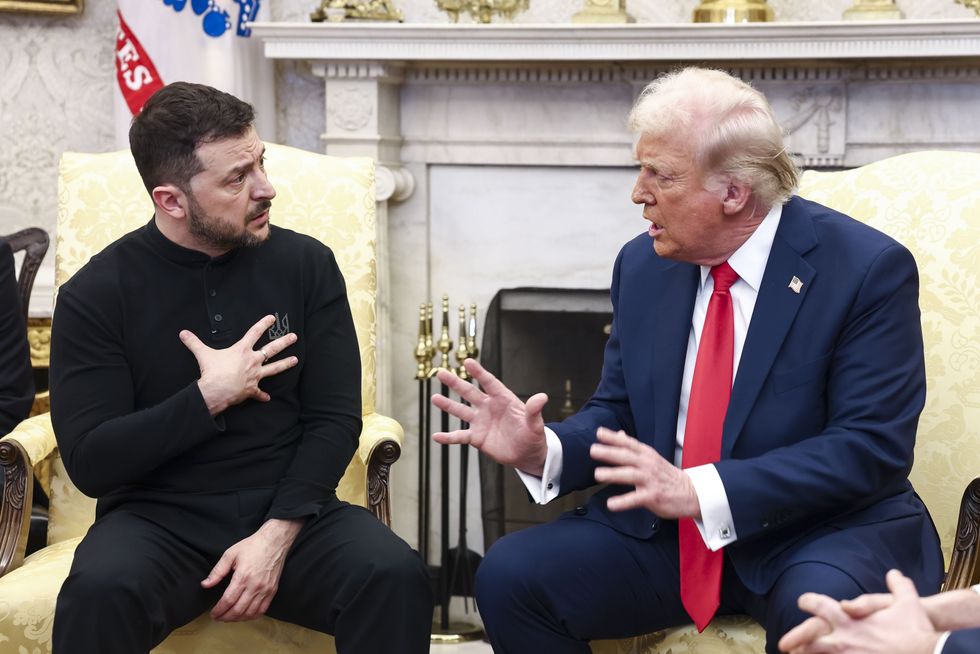 Ukrainian President VOLODYMYR ZELENSKY (L) talks with US President DONALD TRUMP in the Oval Office of the White House in Washington.