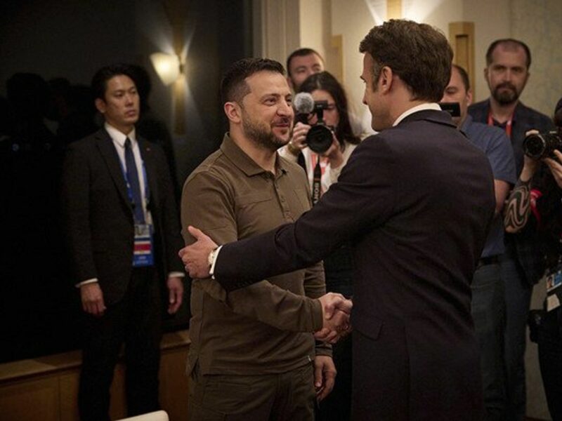 Ukrainian President Volodymyr Zelenskyy, shaking hands with French President Emmanuel Macron.
