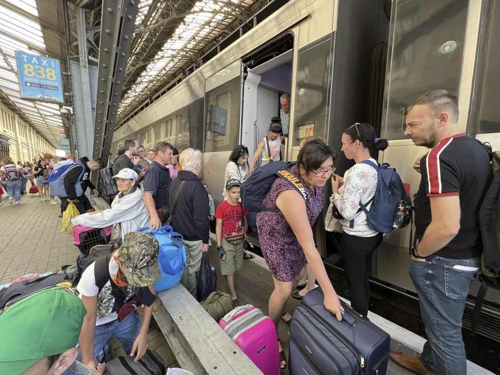 Ukrainian refugees depart the train in Lviv Ukraine