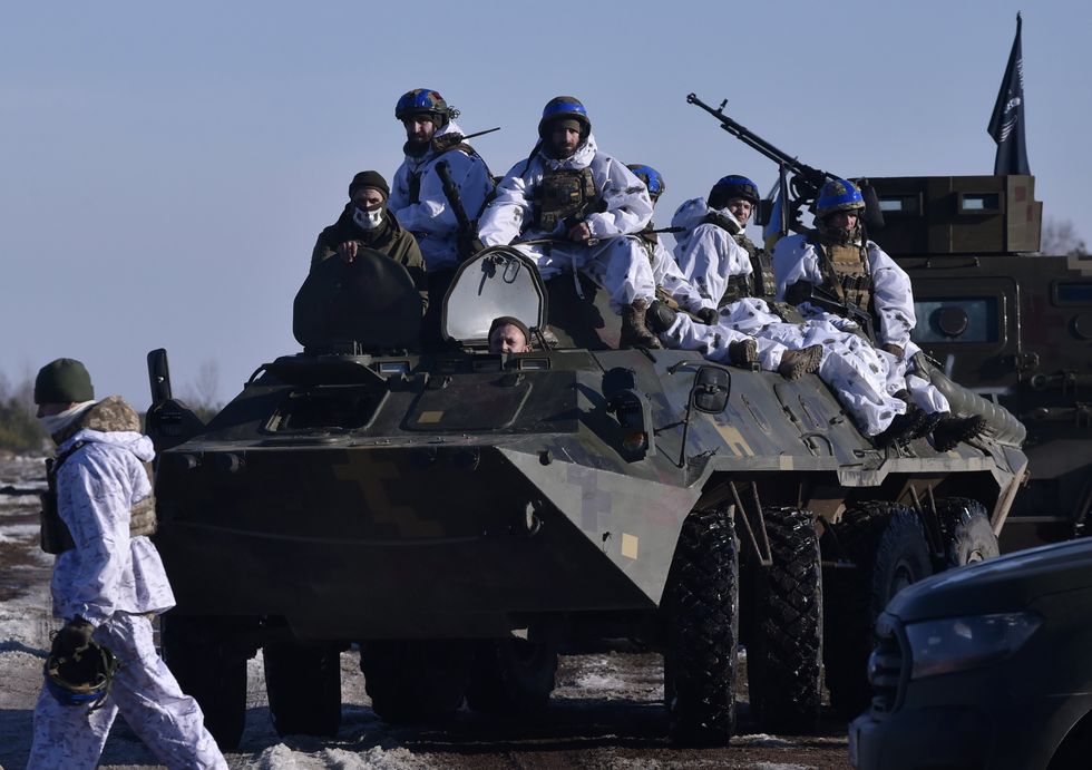 Ukrainian servicemen seen on an armoured personnel carrier (APC) during military exercises in the Zhytomyr region.