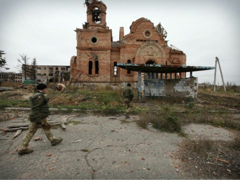Ukrainian soldiers patrol in a destroyed frontline city near Donetsk