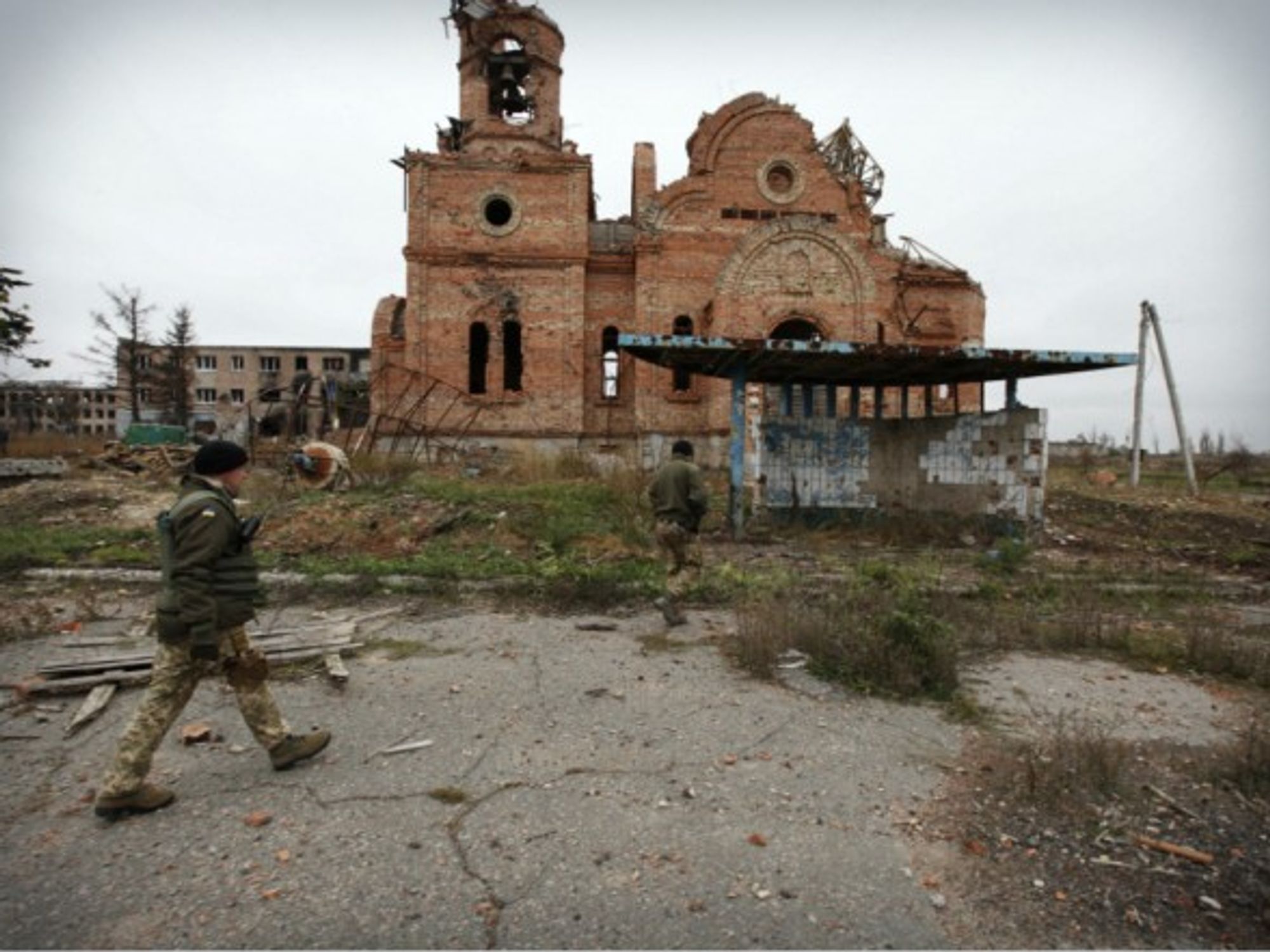 Ukrainian soldiers patrol in a destroyed frontline city near Donetsk