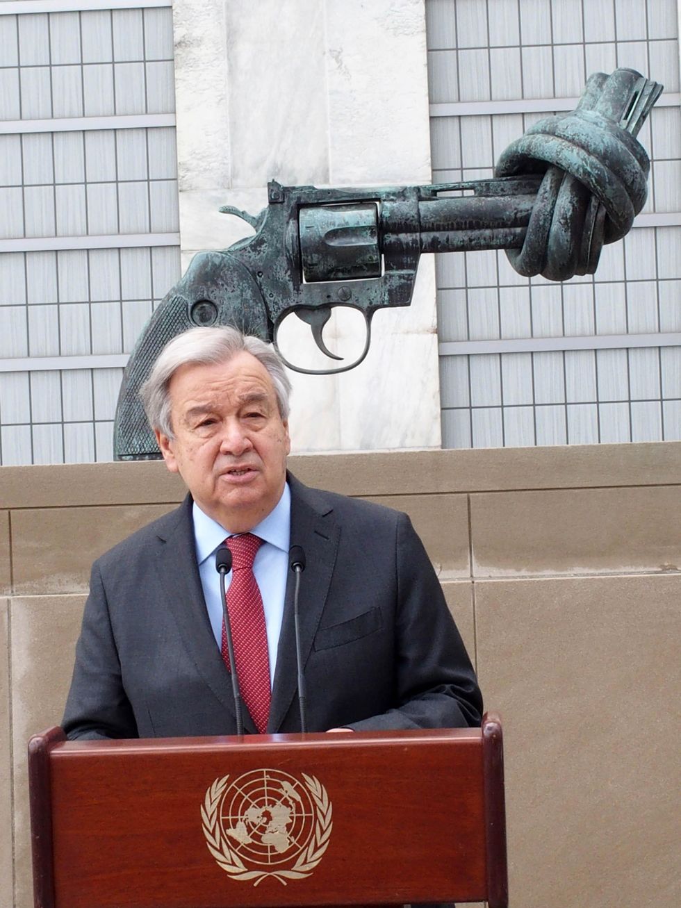 United Nations Secretary General António Guterres in front of the peace sculpture on the United Nation grounds