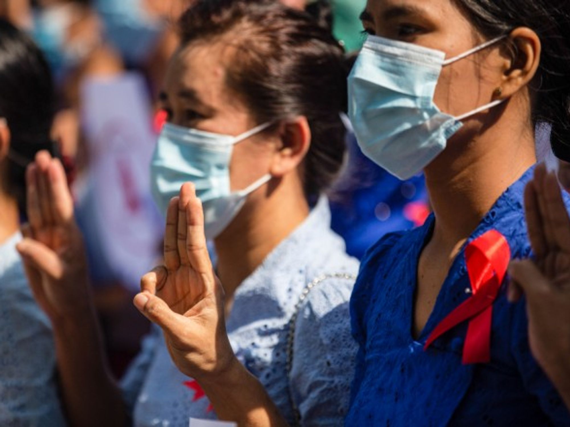 University teachers in Yangon raise the three finger salute to protest the military coup in Myanmar