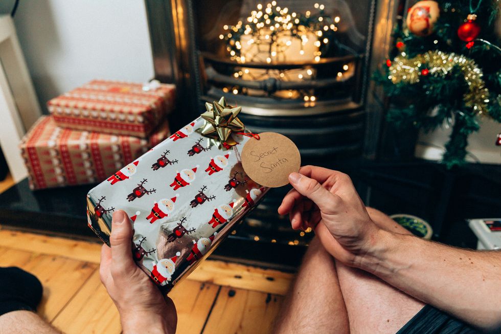 Various wrapped christmas gift under christmas lights
