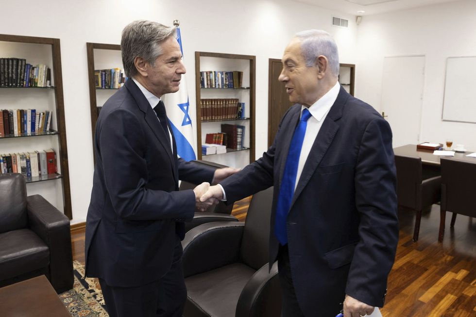 v​U.S Secretary of State Antony Blinken and Israeli Prime Minister Benjamin Netanyahu shake hands in a Tel Aviv office.