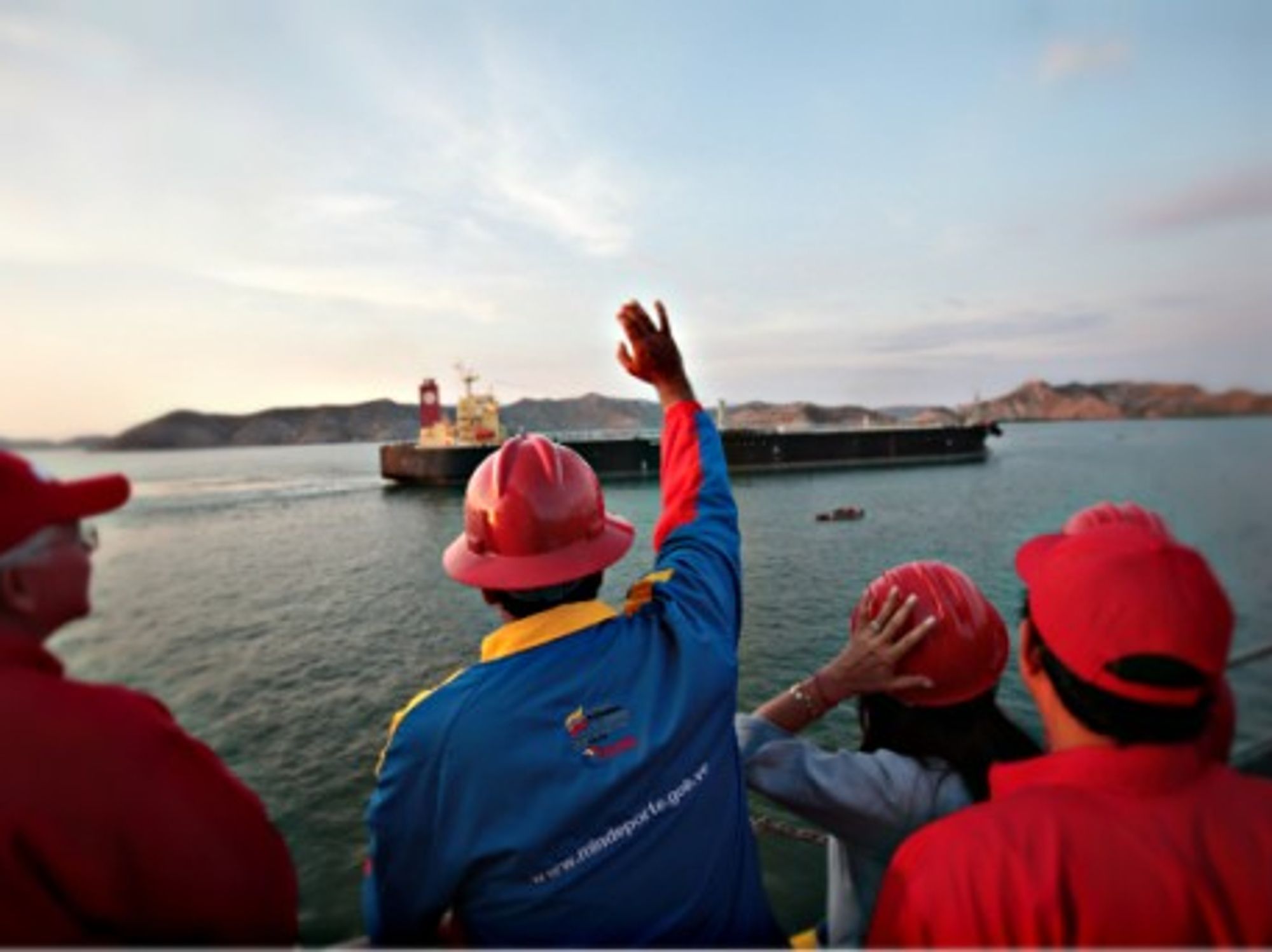 Venezuelan President Nicola Maduro waving at an oil tanker