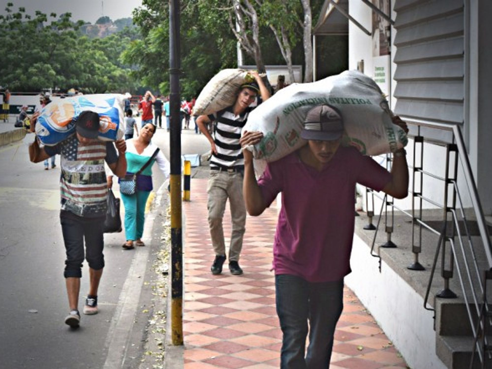 Venezuelans carry food across the Colombian border last December.