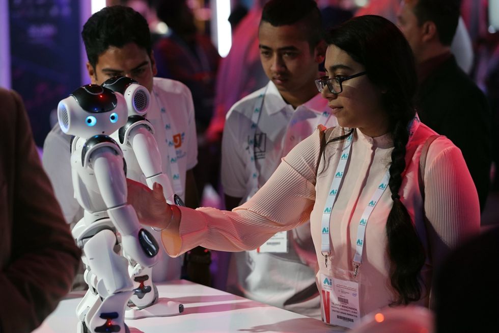 Visitors look at robots displayed at the first AI Everything Summit in Dubai.