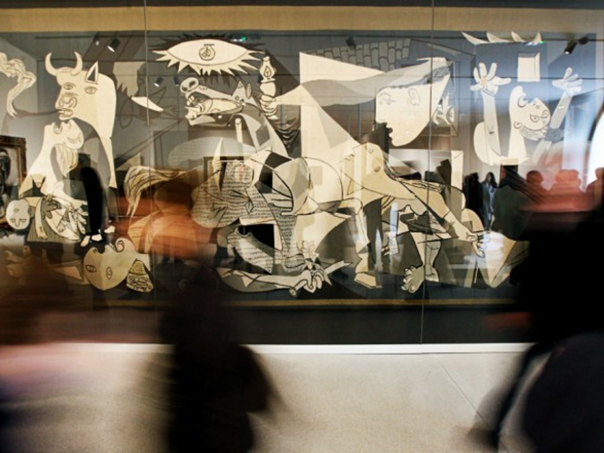 Visitors walking past Guernica