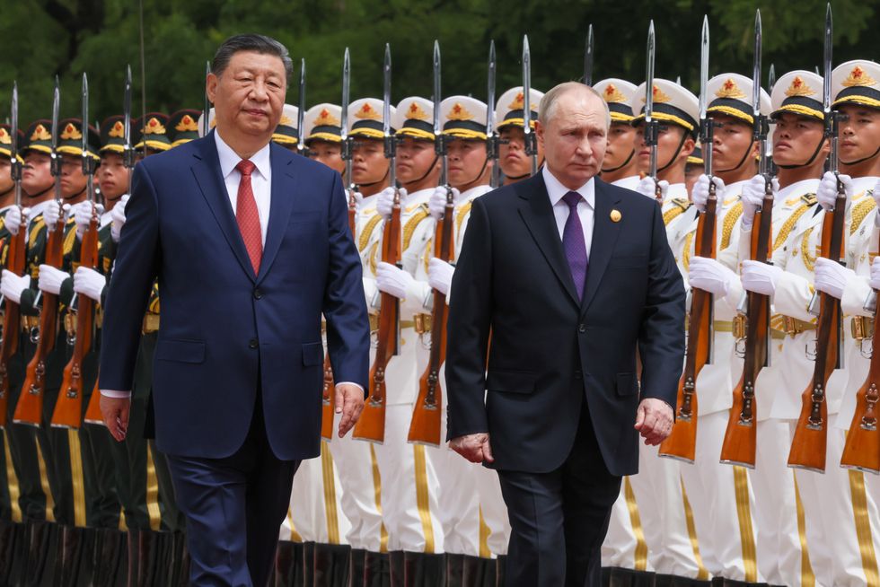 Vladimir Putin and President Xi Jinping in front of the Great Hall of the People in Tiananmen Square.