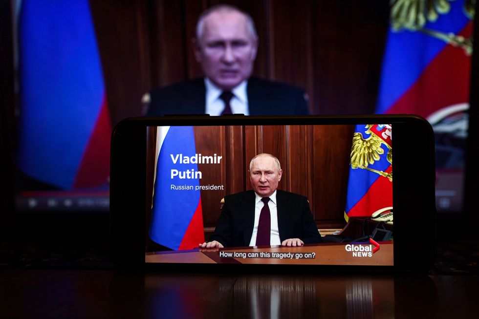 Vladimir Putin speaking on TV.
