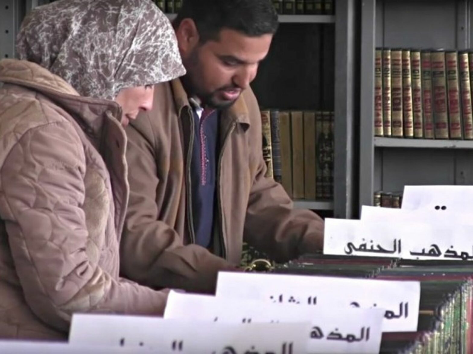 Volunteers of pore through some of the books that have been rescued from the rubble of war-torn Syria.