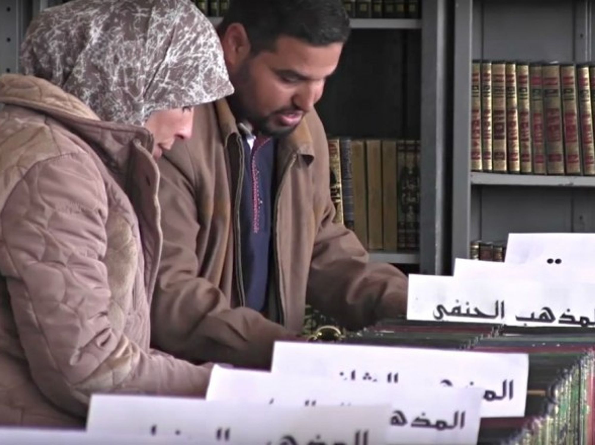 Volunteers of pore through some of the books that have been rescued from the rubble of war-torn Syria.