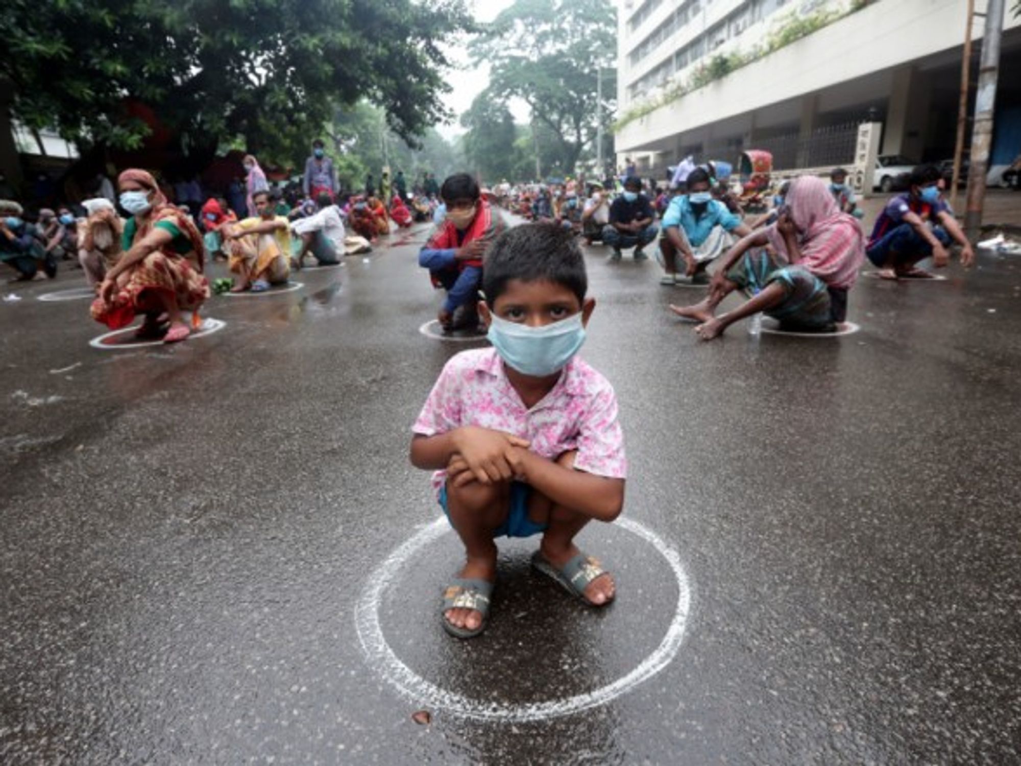 Waiting for free food in Dhaka, Bangladesh, as the new strict nationwide lockdown was extended following record highs in new COVID-19 cases and deaths.