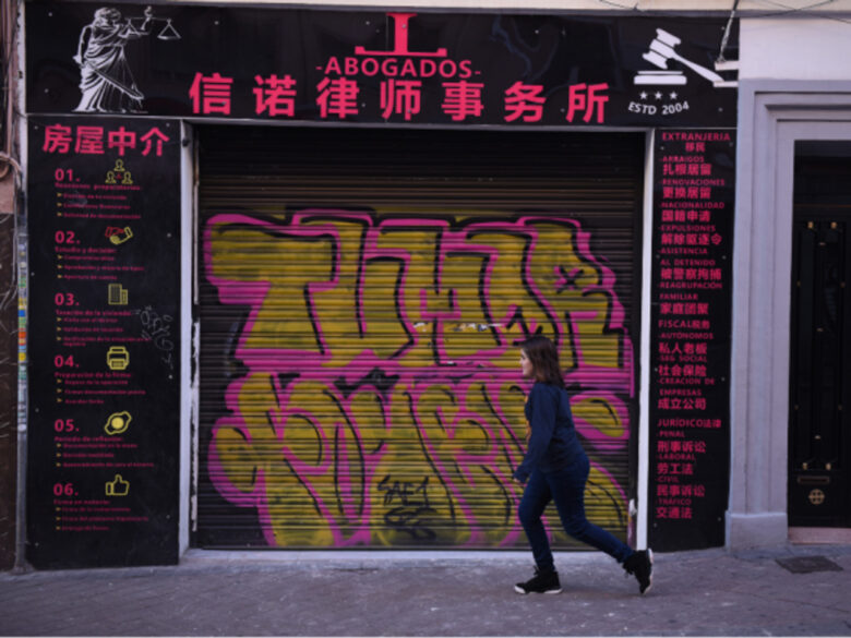 Walking past a closed Chinese shop in Madrid's Usera district