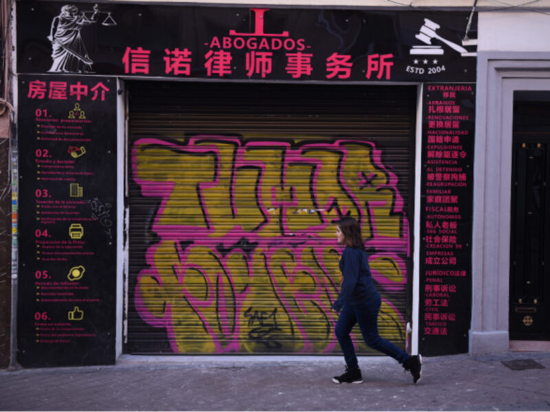 Walking past a closed Chinese shop in Madrid's Usera district