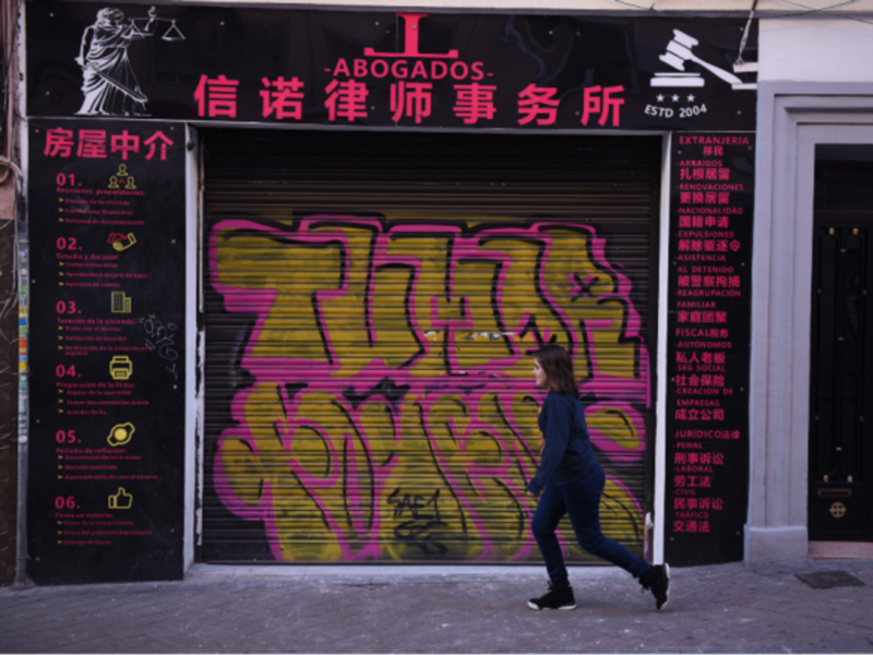 Walking past a closed Chinese shop in Madrid's Usera district
