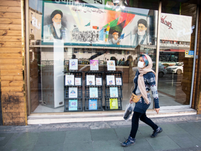 Walking past portraits of Khamenei and late Ayatollah Khomeini in Tehran