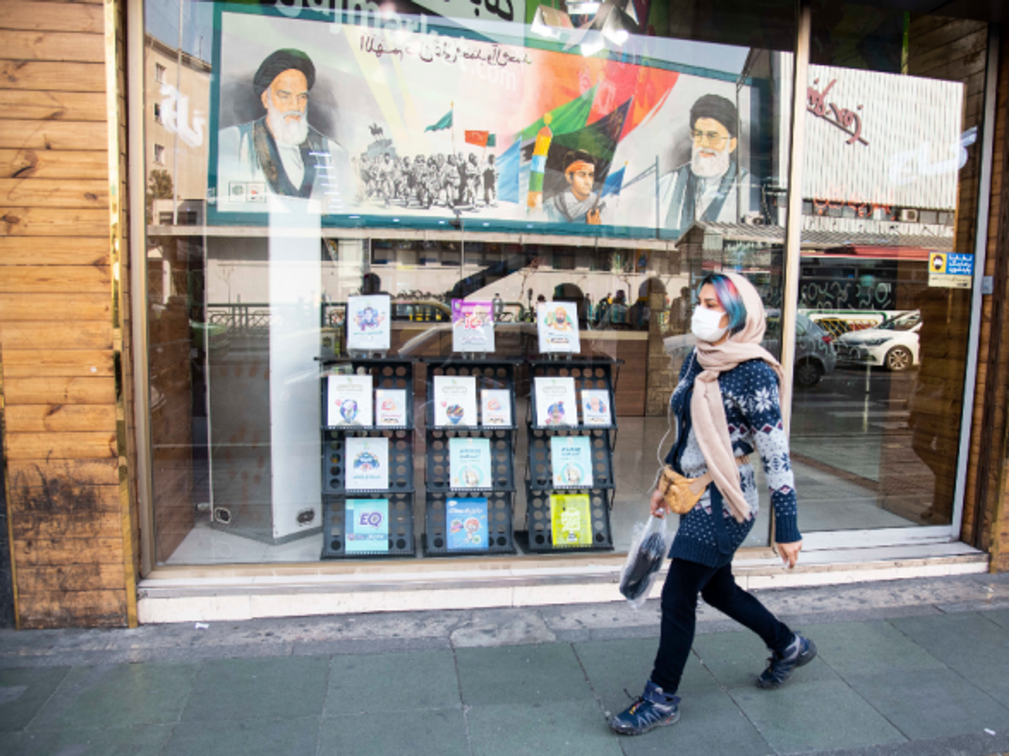 Walking past portraits of Khamenei and late Ayatollah Khomeini in Tehran