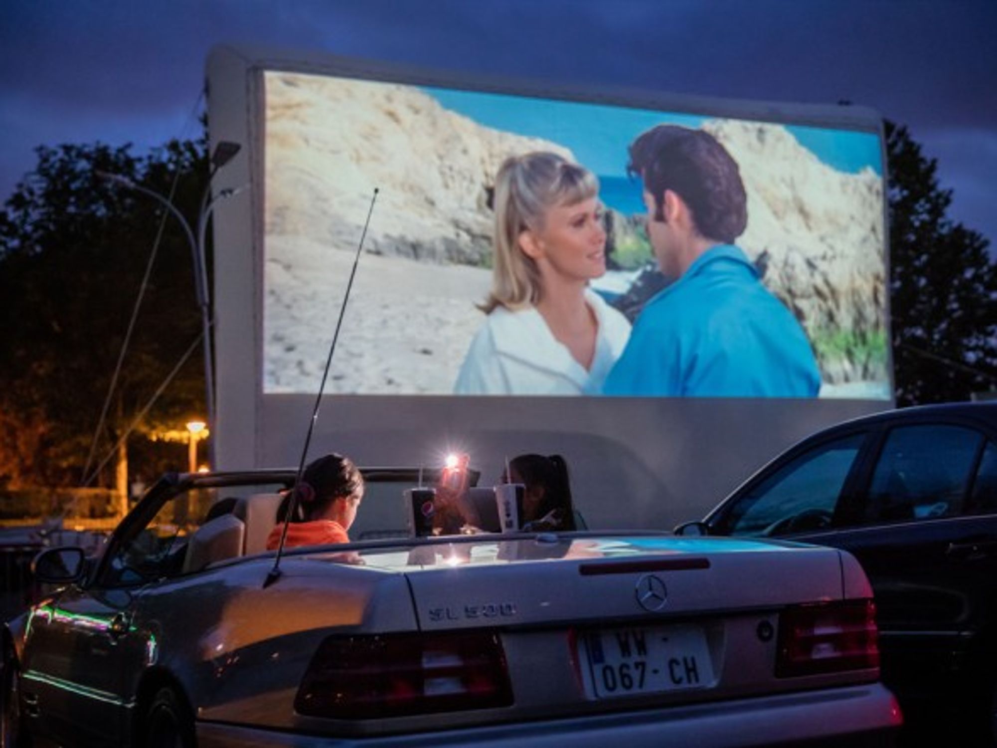Watching a movie at a drive-in theater