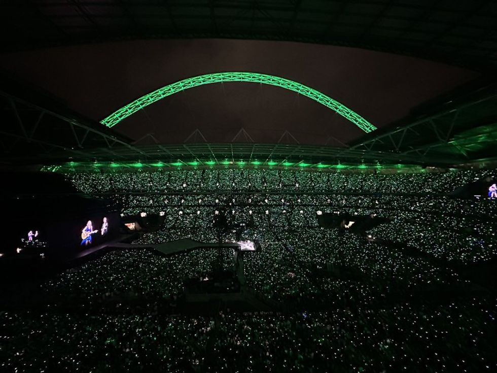 Wembley Stadium lights up in green on the 8th and last night of Swift's Eras Tour in London.