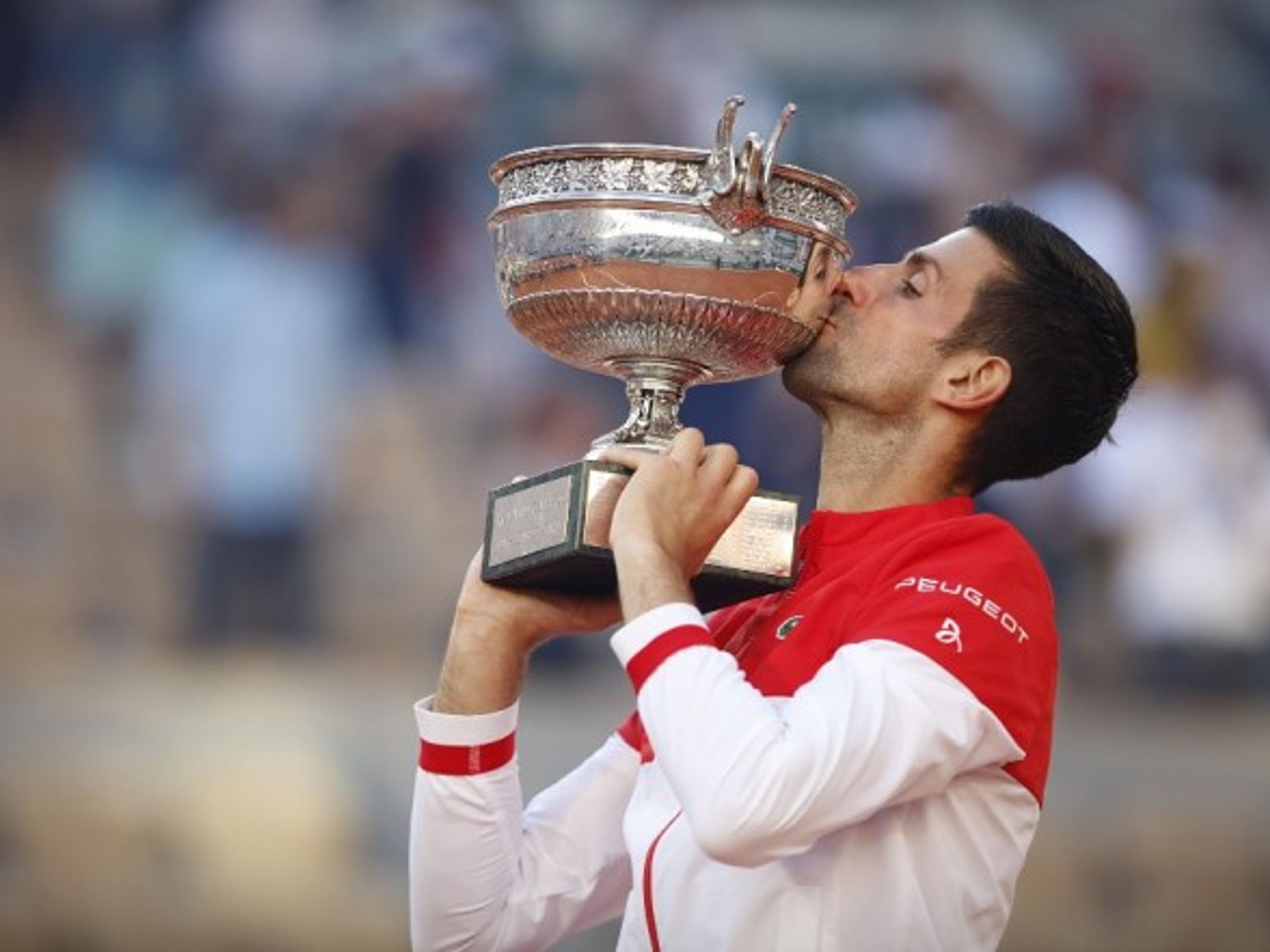 Winner Novak Djokovic of Serbia kisses trophy after the final match of the French Open