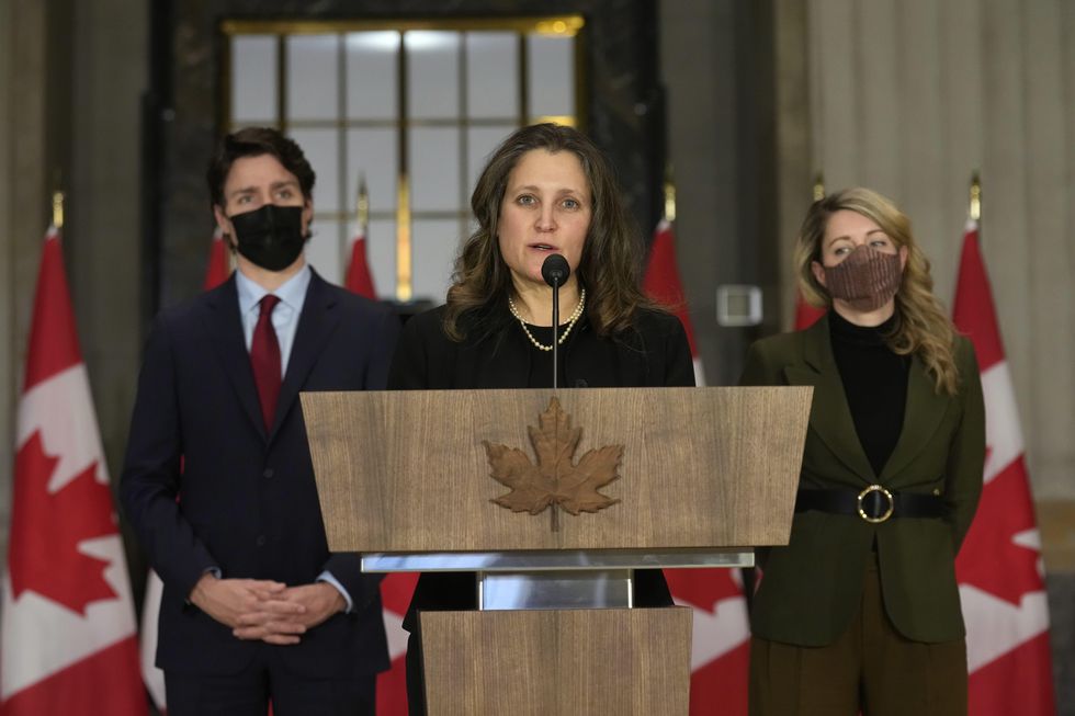 With Prime Minister Justin Trudeau and Foreign Affairs Minister Melanie Joly looking on, Freeland speaks in Ottawa just after Russia launched its invasion.