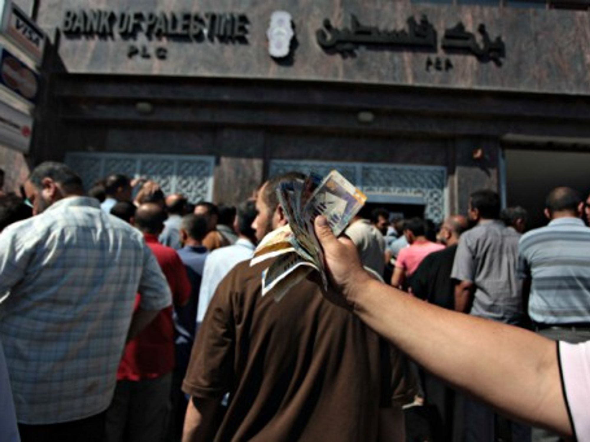 Withdrawing cash at a Gaza ATM.