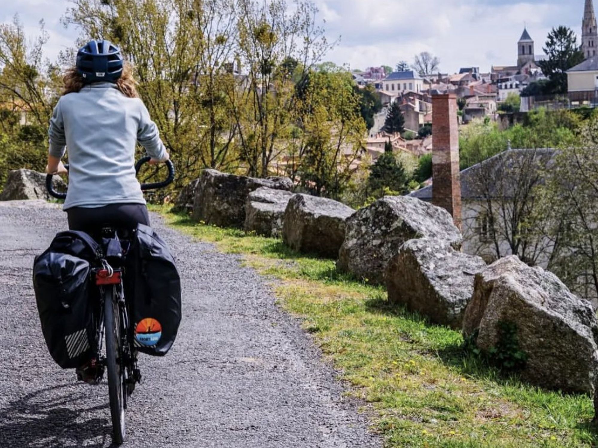 Woman biking at the Thouet Valley during a microadventure.