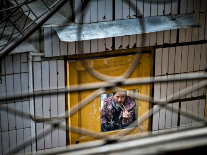 Woman eating with chopsticks in Songpan county, China