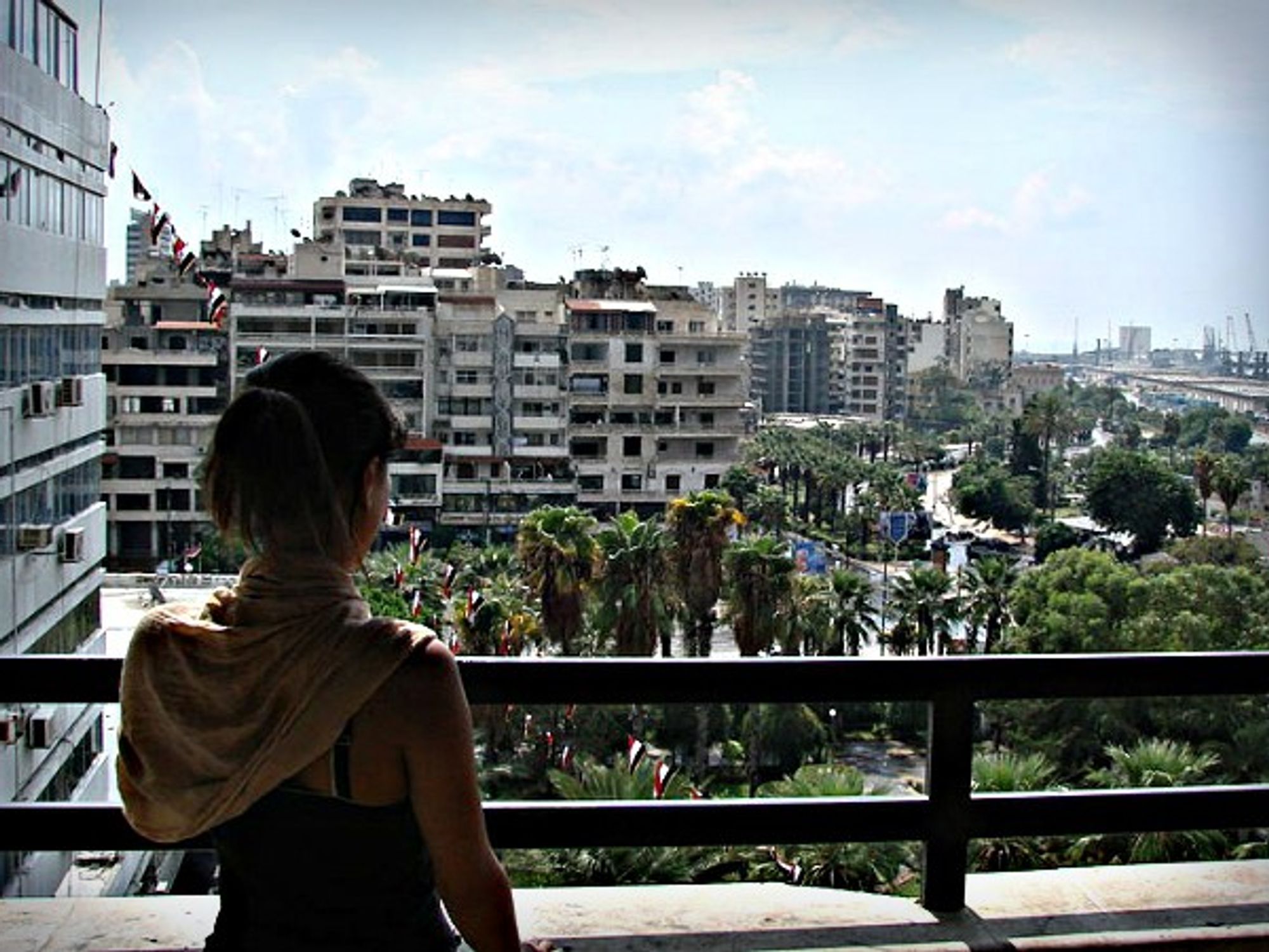 Woman on balcony in Latakia, Syria