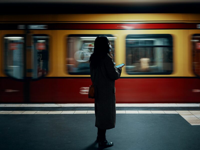 Woman standing in front of a train.
