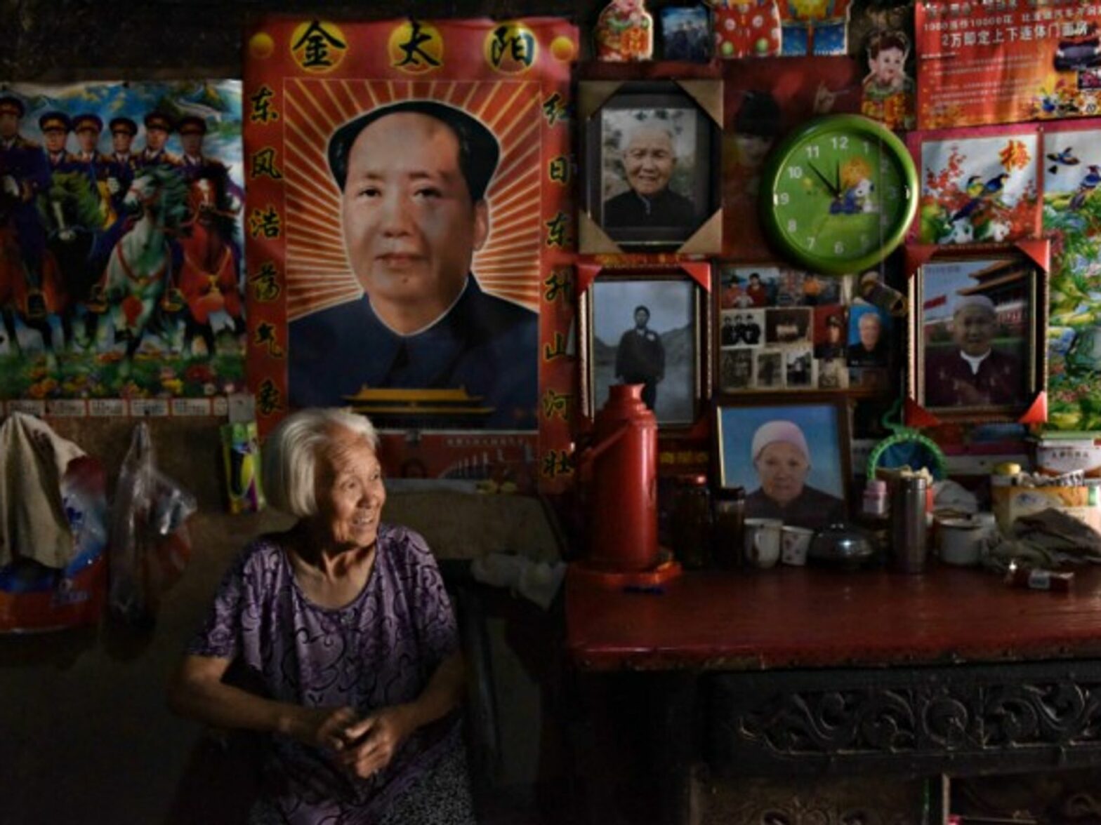 Woman under a portrait of Mao in Yuncheng, China