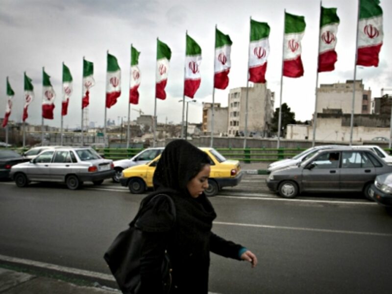 Woman walking in a busy Tehran street