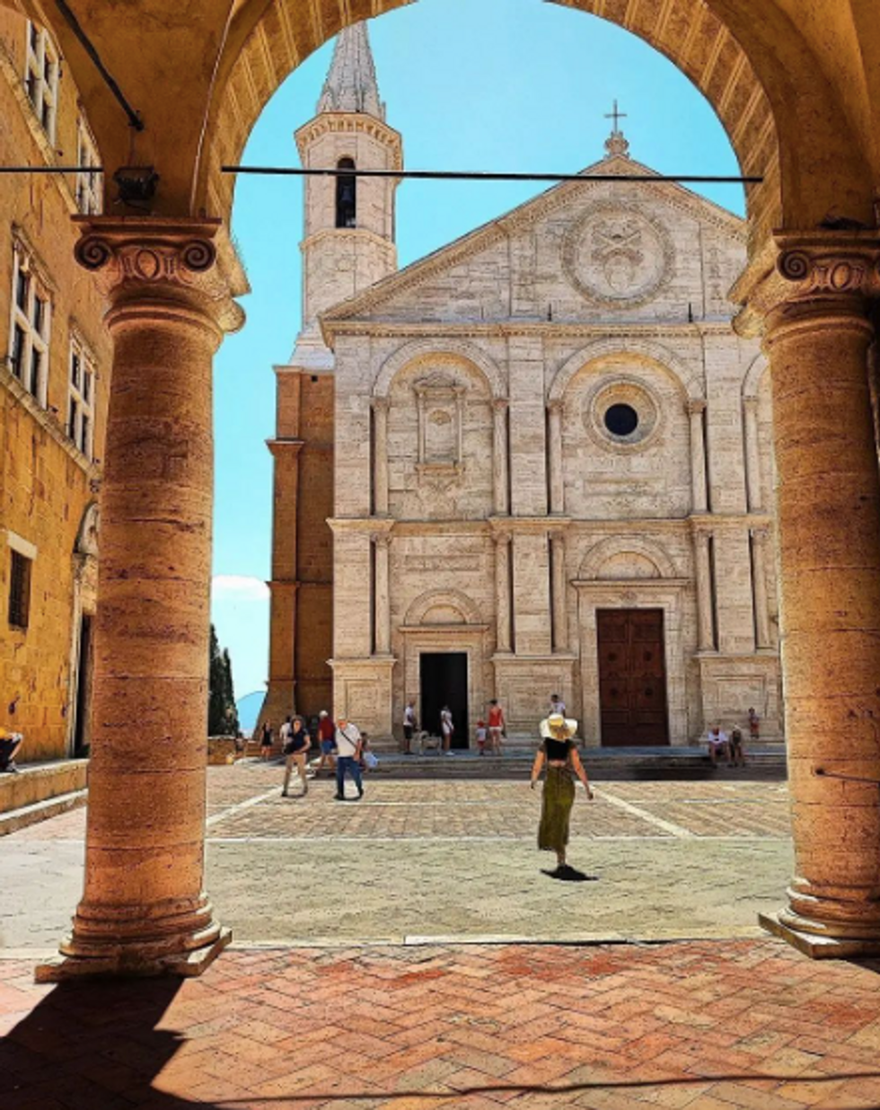 Woman walking through the streets of Pienza.