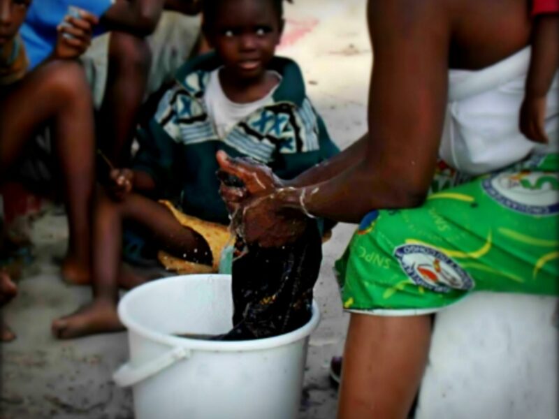 Woman washing black clothes in Brazzaville, Republic of the Congo