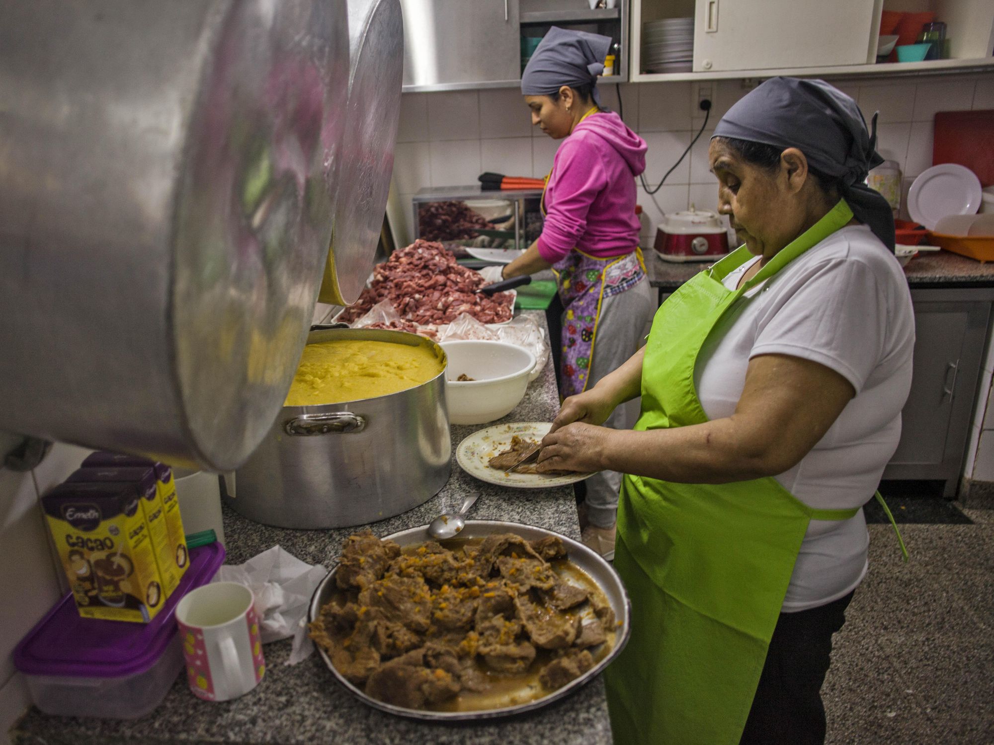Women cooking for young people in Argentina