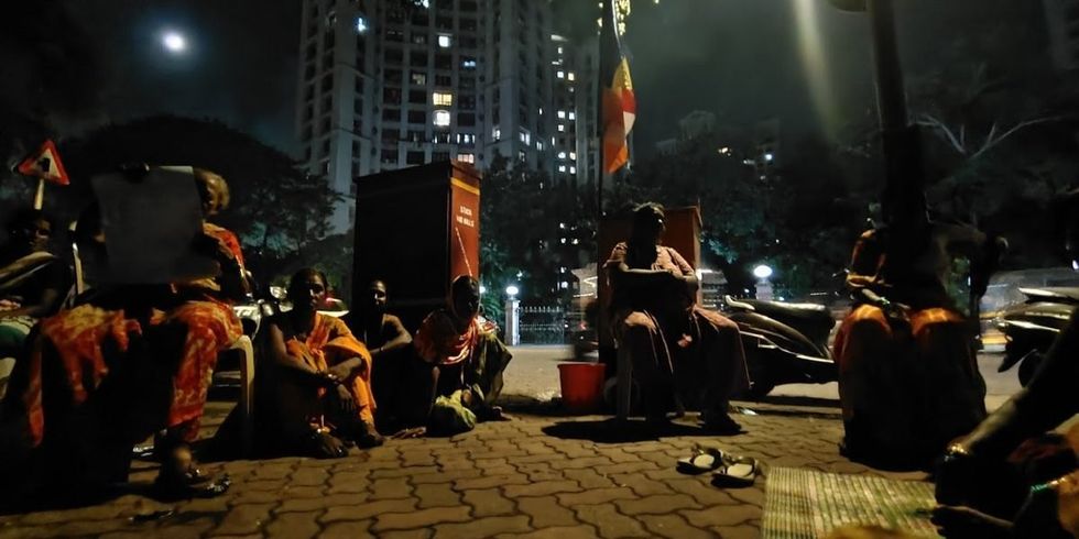 Women from the Jai Bhim Nagar slums sat in front of the Hiranandani complex.