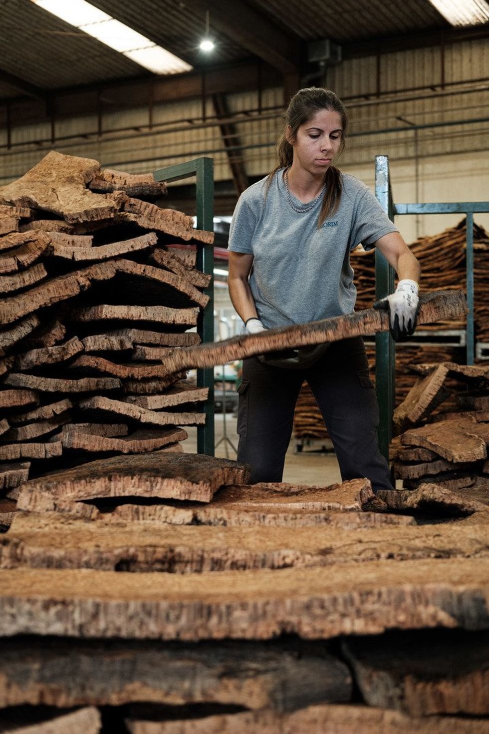 Women lifting pieces of cork.